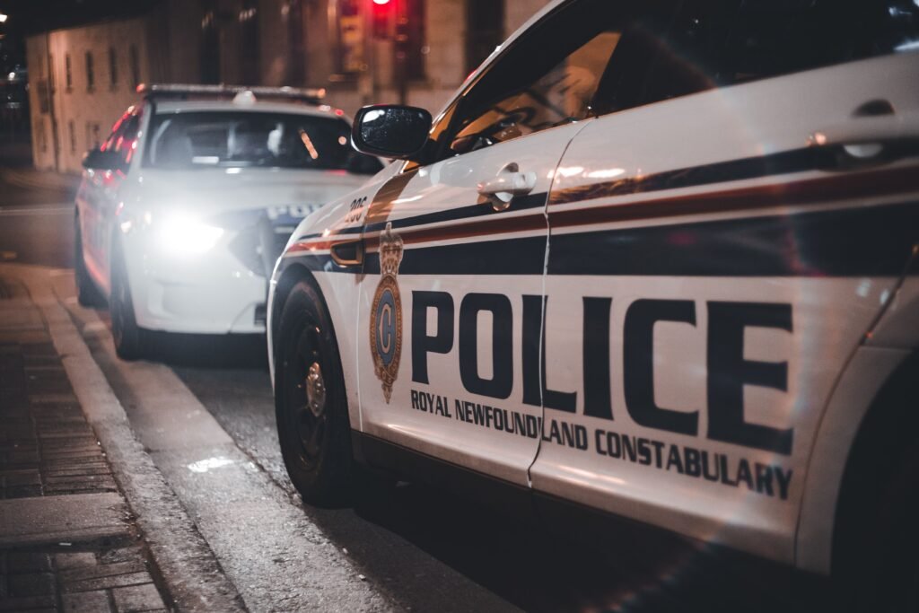 Close-up of Royal Newfoundland Constabulary police cars parked on a street at night.